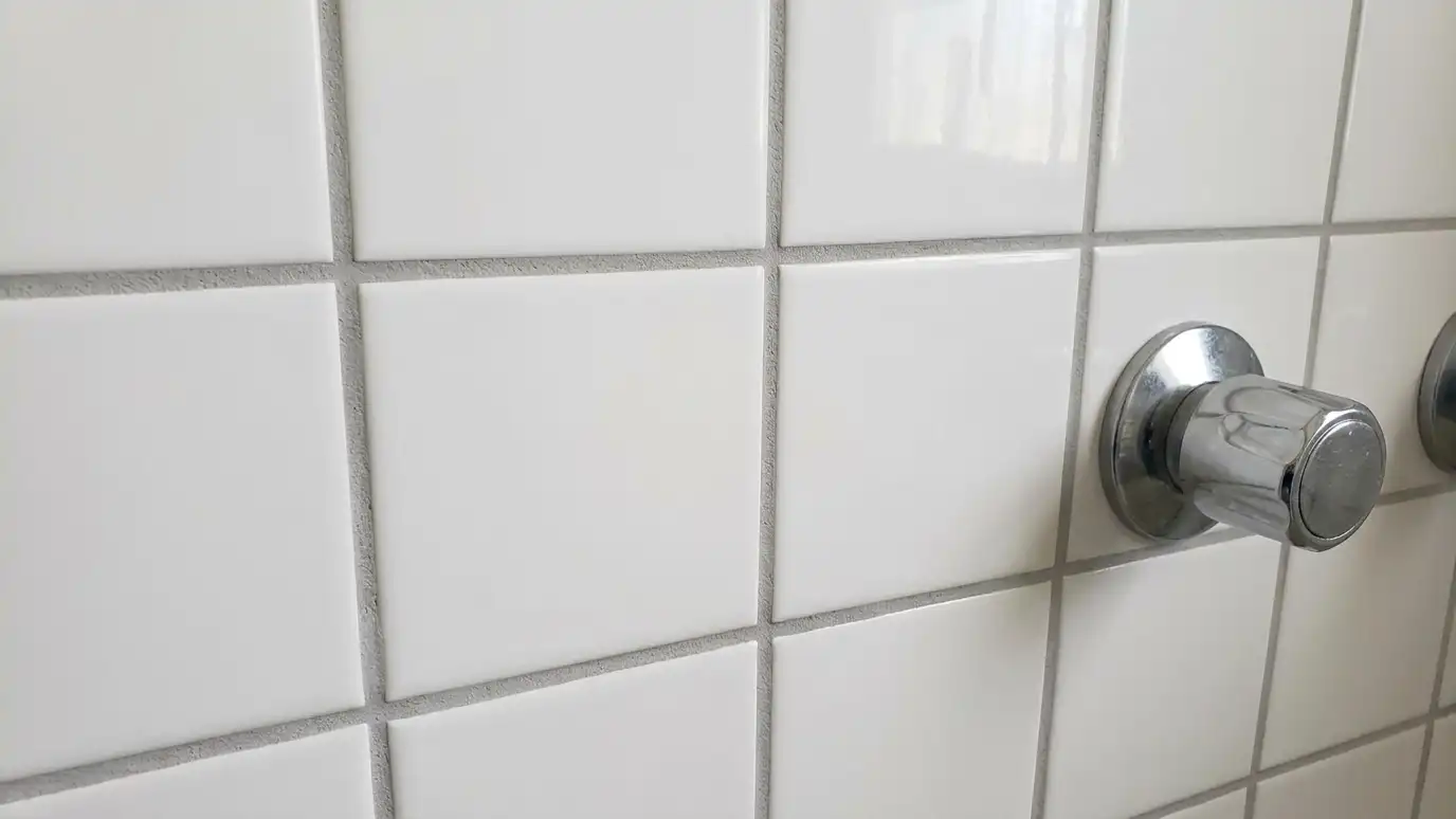 After: Dark, cracked grout made fresh and clean | Music City Shower Service After: a shower wall with the same tile with clean, uniform light gray grout